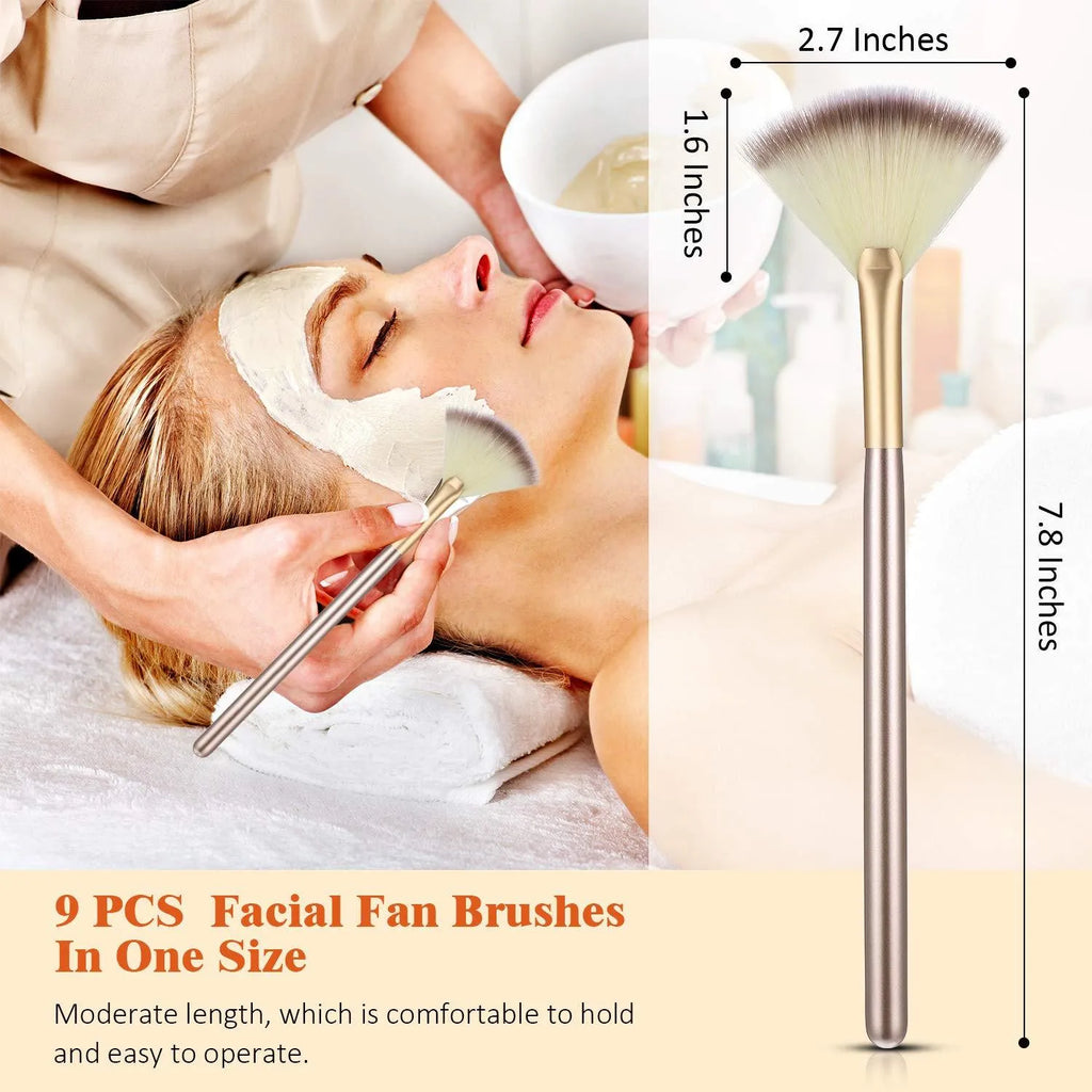Ten champagne-coloured facial fan brushes with acrylic handles and protective covers laid out.
