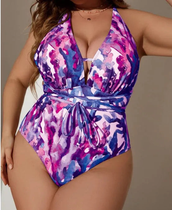 Women's solid purple one-piece halter swimsuit on a mannequin, showing briefs style cut.