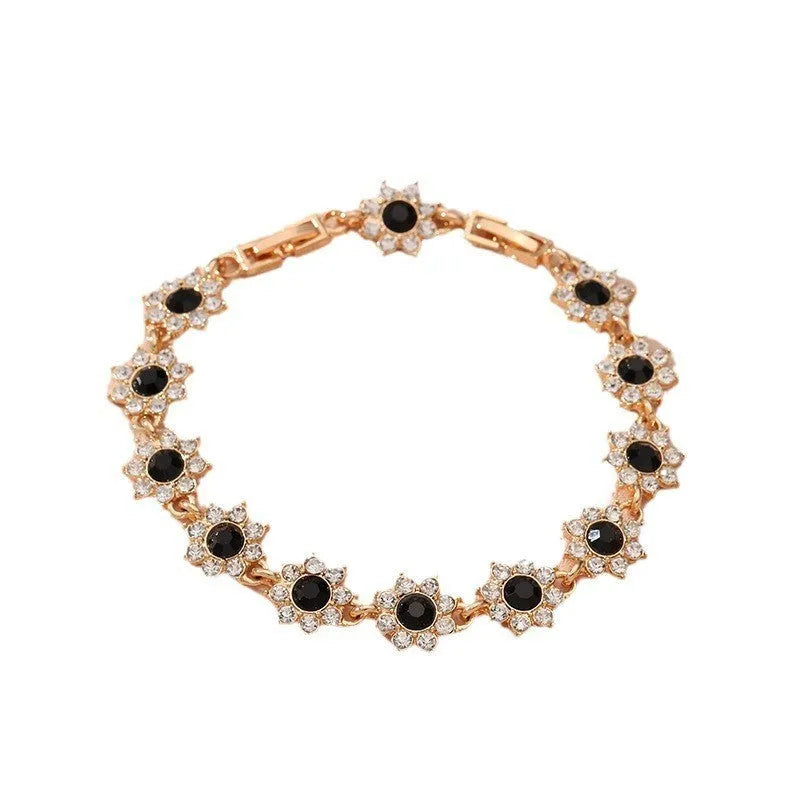 Electroplated zinc alloy bracelet with flower-shaped coloured gemstone charm in gold and silver colour variations