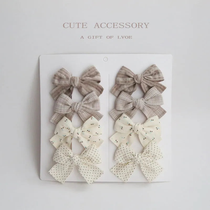 Children's fabric bow hairclips set showing dovetail design in multiple colour options