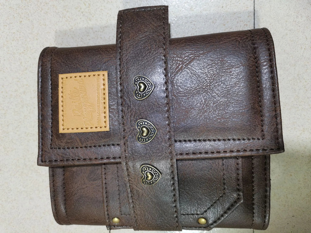 Brown retro notebook with buckle closure showing loose-leaf binding and A7 size