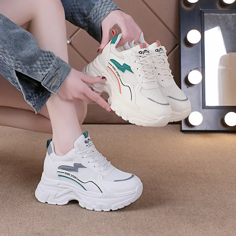 Women's white breathable mesh sports shoes with cross shoulder straps and built-in height increasing insoles.