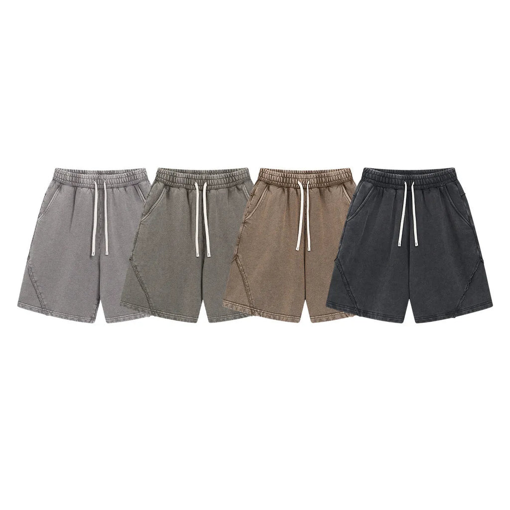 Men's loose black batik washed cotton shorts with patch craft design on a neutral background.