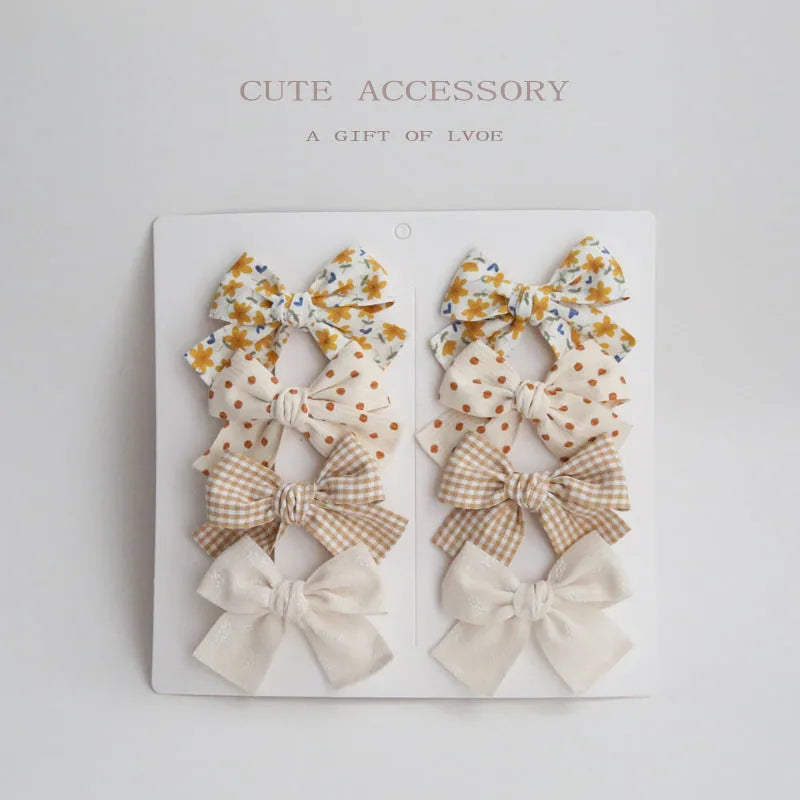 Children's fabric bow hairclips set showing dovetail design in multiple colour options