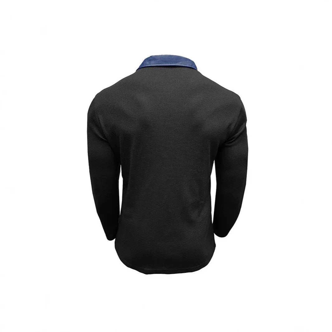 Man modelling a loose-fit long-sleeved waffle-knit polo shirt in a solid colour with an asymmetrical style detail.
