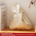 Chinese style gold silk jacquard hand-held cloth gift bag with flower accent in champagne colour on white background
