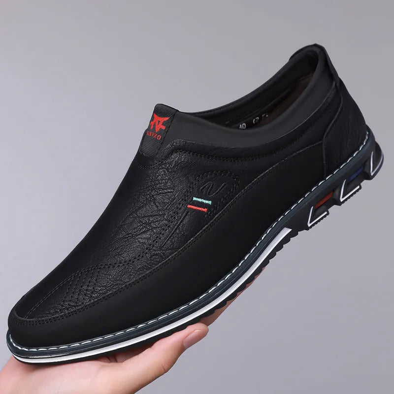Men's black leather toe cap casual shoes with a fabric upper and rubber sole on a white background.