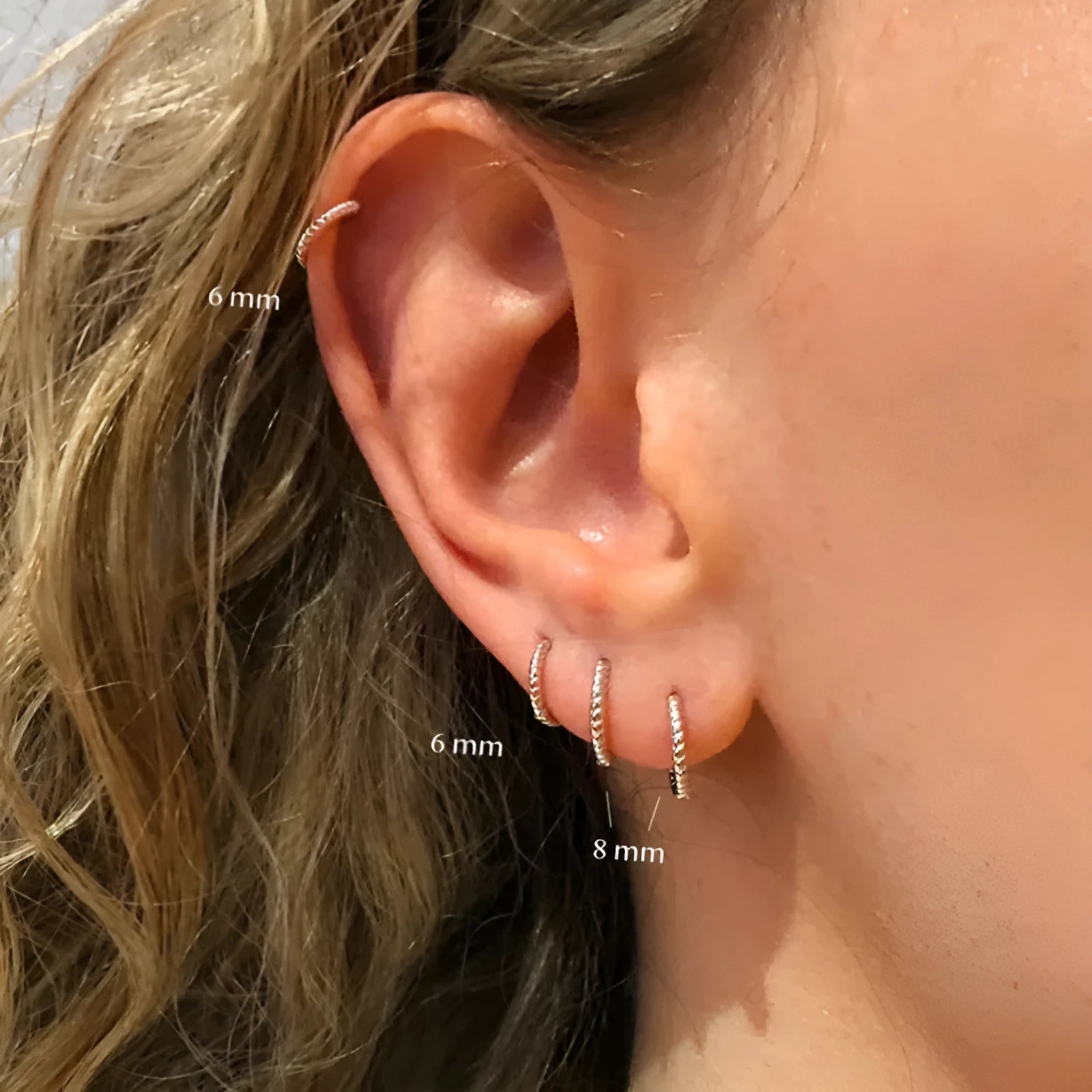 Sterling silver twisted hoop earrings with geometric round shape in gold electroplated finish