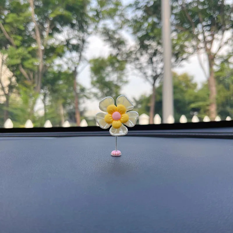 Small colourful plastic swing car decoration hanging ornament in blue, green, pink, purple, or yellow.