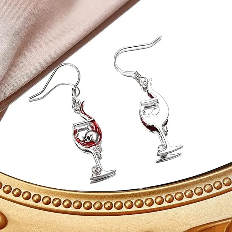 A pair of metallic geometric skull wine glass earrings for women, shown in dark gothic style.