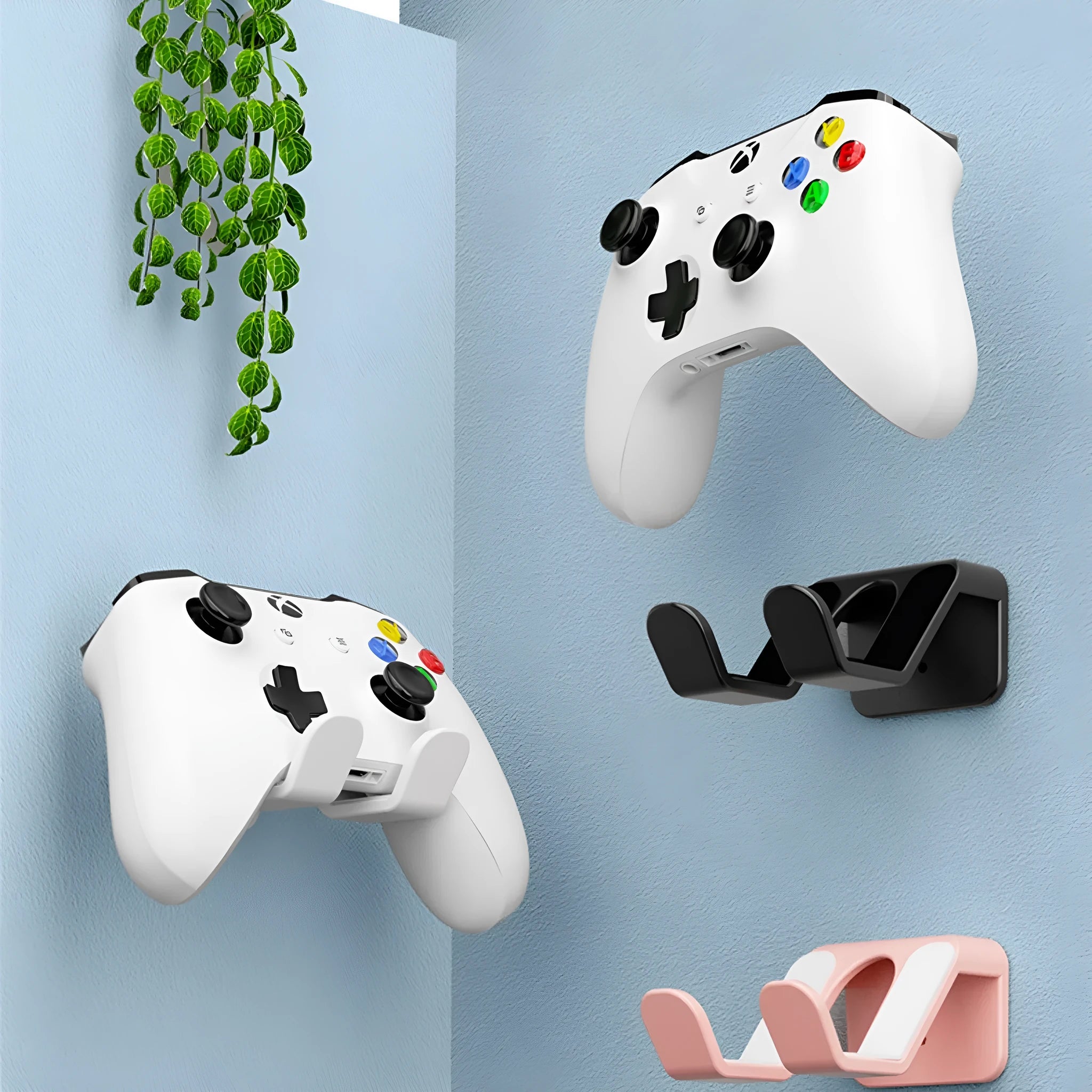 Black ABS plastic universal wall-mounted hanging rack holding a game controller and a gaming headset.