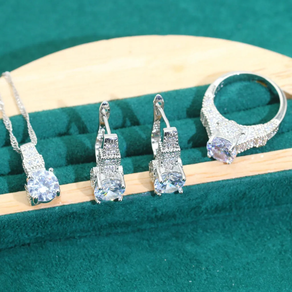 Four-piece bridal jewellery set showing necklace, earrings, ring, and bracelet with alloy pendant and water wave chain