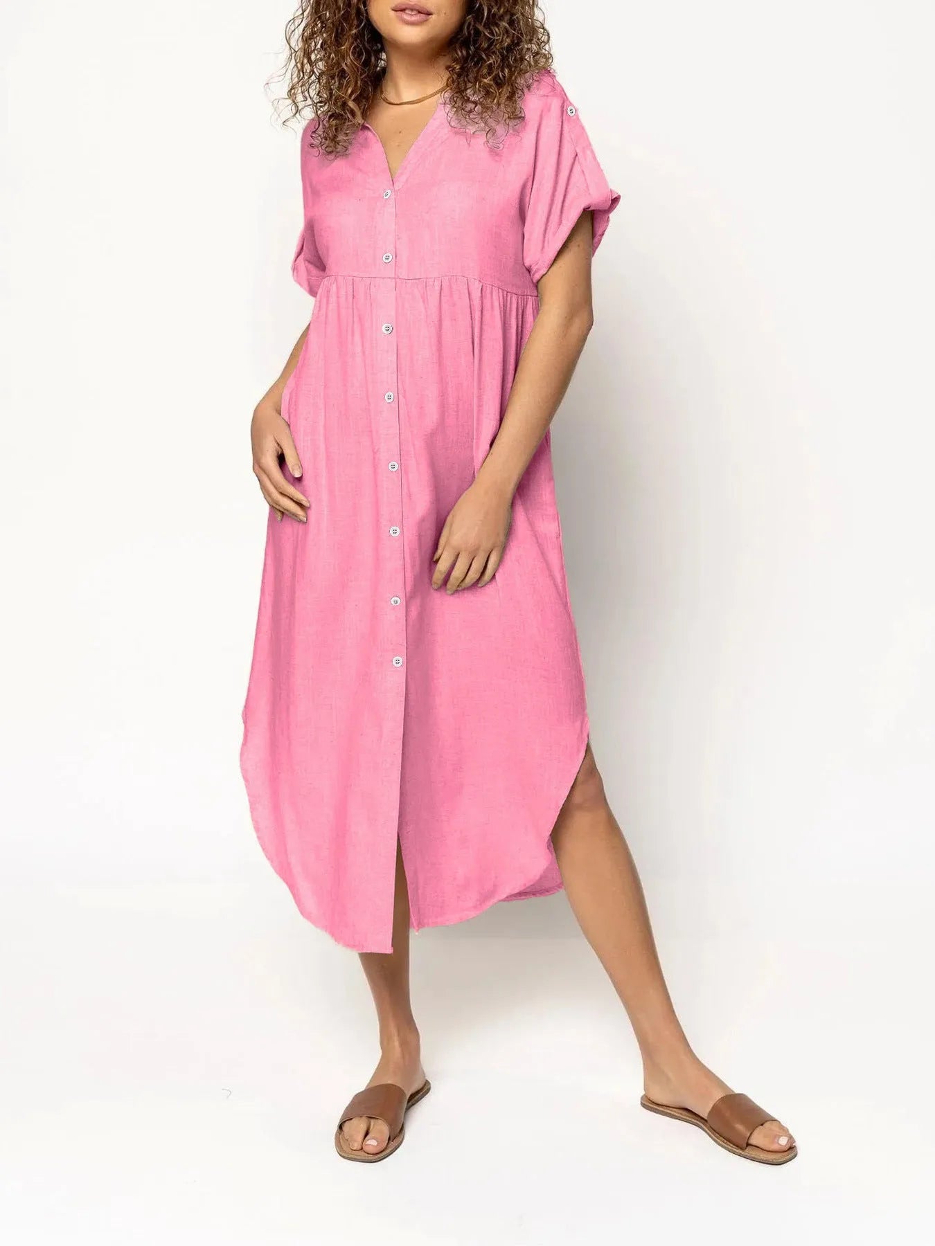 A loose-fitting, solid colour mid-length casual dress with a button-down front and regular sleeves.