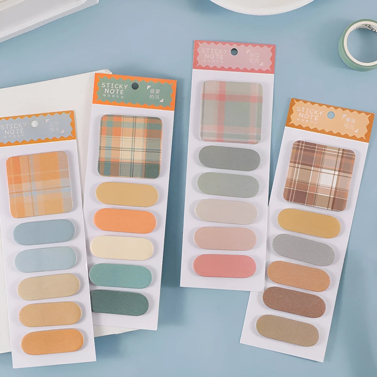 Set of six colourful plaid design sticky note memo pads, each with 20 sheets, showing various solid colours.