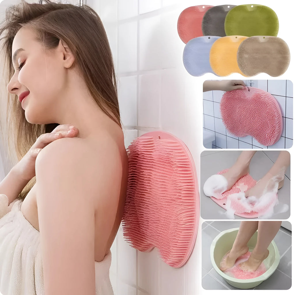 Orange silicone bath massage brush mat with suction cups on a bathroom floor