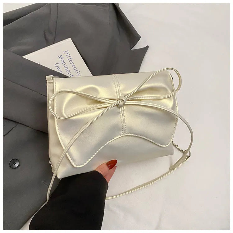 Women's underarm crossbody bag in horizontal square shape with sewing line details and phone pocket