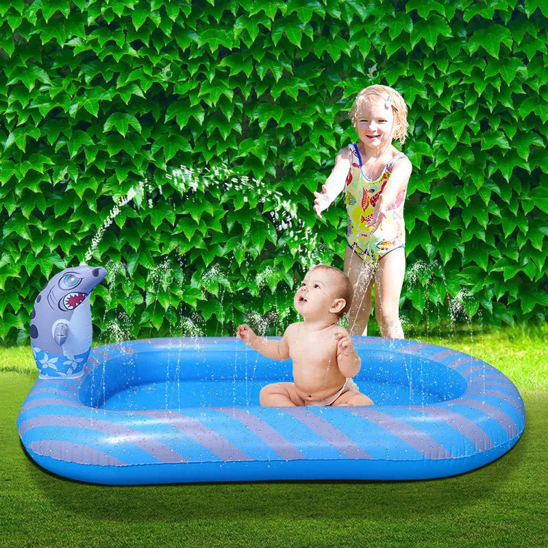Blue and yellow inflatable dinosaur and shark themed water spray pool for kids in a garden.