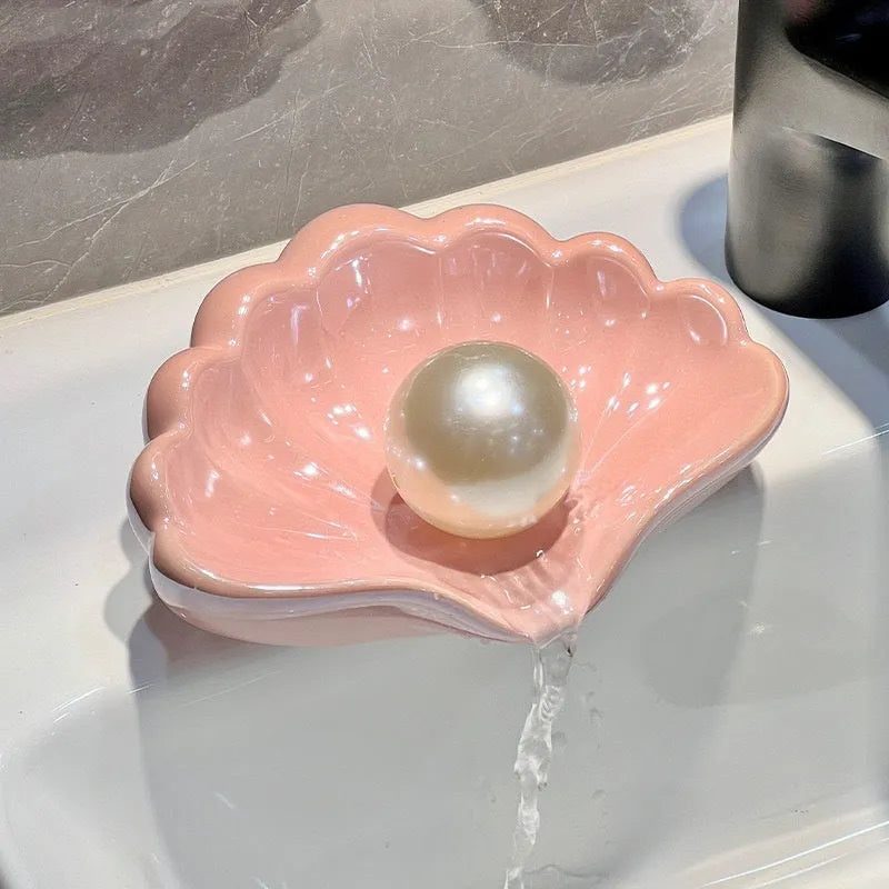 White or pink plastic shell-shaped soap dish for bathroom sink storage
