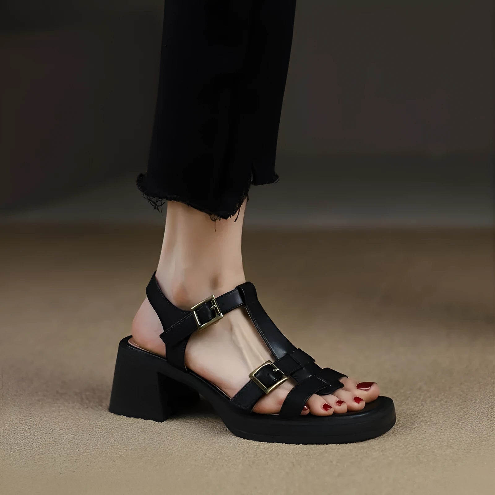 Black women's retro platform sandals with a T-buckle strap and chunky heel.