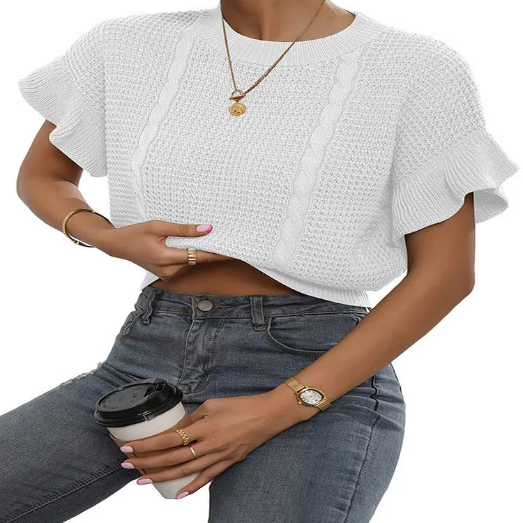 Loose-fitting white knitted pullover sweater with textured ruffled short sleeves on a model.
