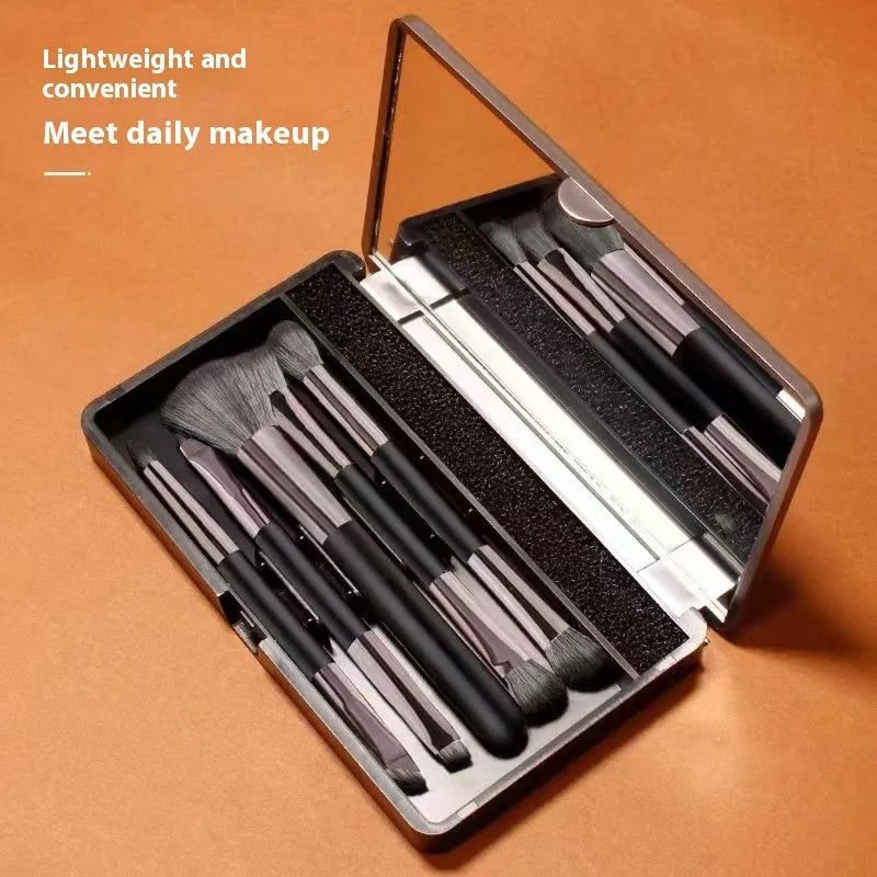 Portable makeup brush set with mirror showing eyeshadow brushes with artificial fibre bristles