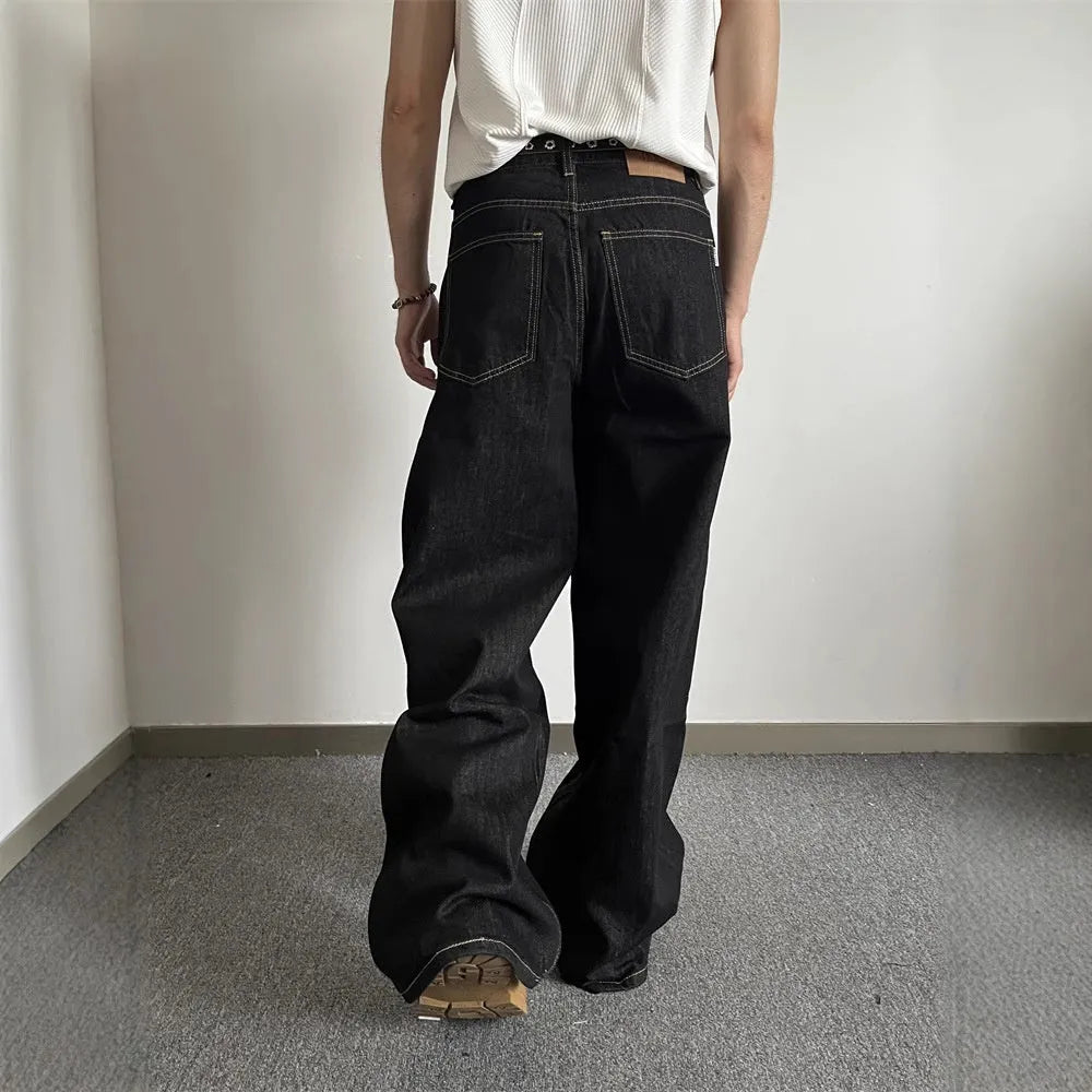 Black loose fit wide-leg denim jeans with a straight leg and mid waist on a hanger.