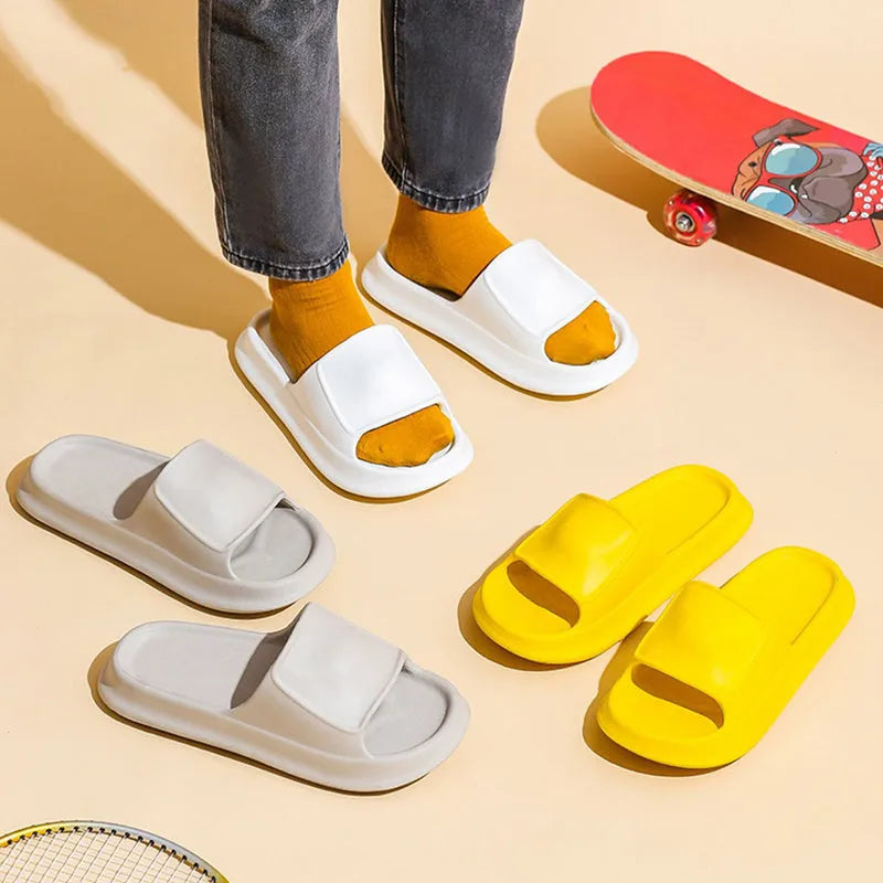 Thick-soled EVA flip-flop slippers in multiple colours on a bathroom floor, showing non-slip sole texture.