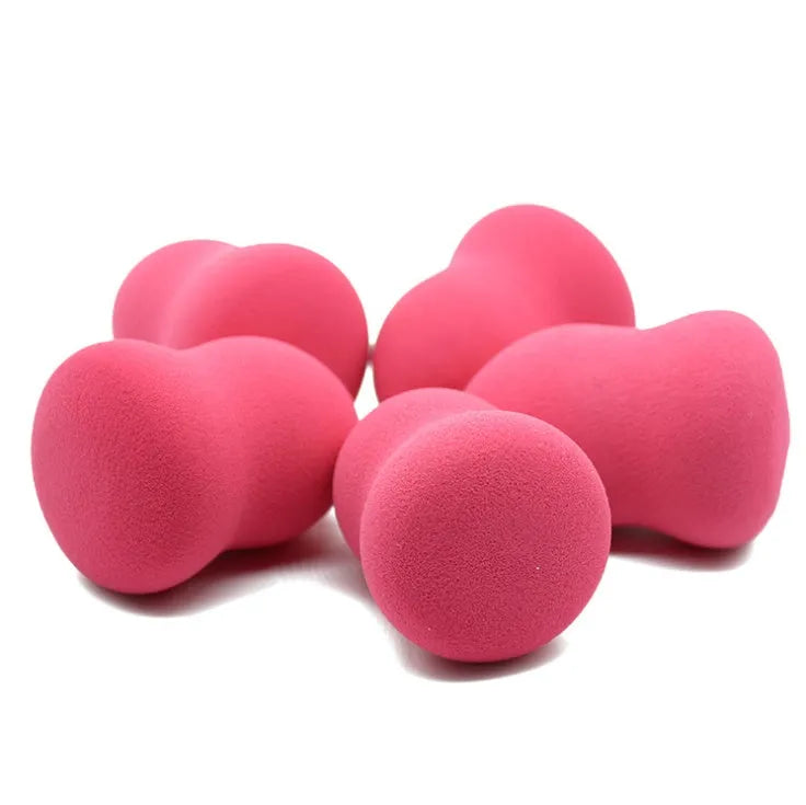 Pink teardrop makeup blending sponge on a plain background.