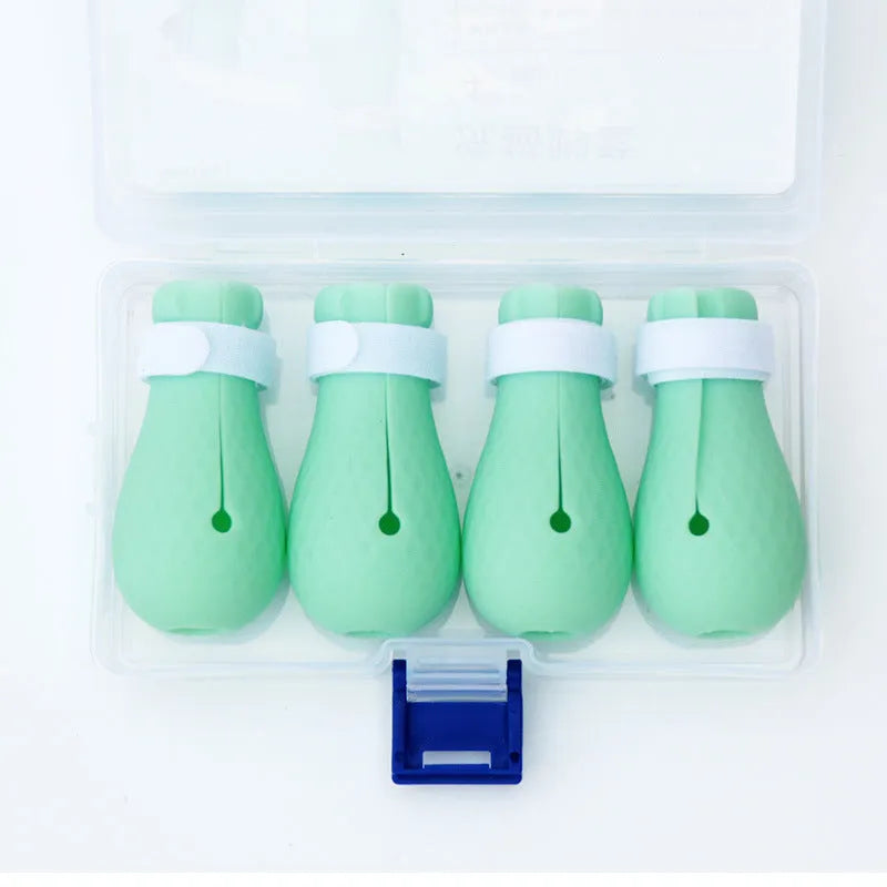 Four green silicone anti-scratch gloves designed to cover a cat's paws.