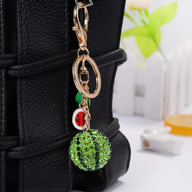 Green zinc alloy watermelon slice keychain on a metal ring