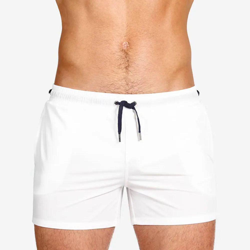 Men's solid colour polyester sports shorts with mesh lining, shown in Army Green, for swimming and fitness.