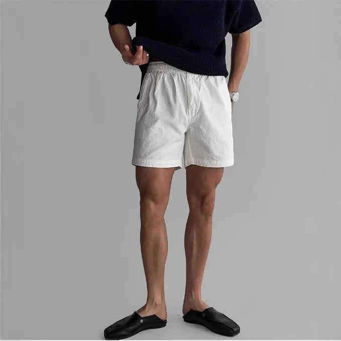 Men's loose-fit cotton sports shorts in black, shown on a white background