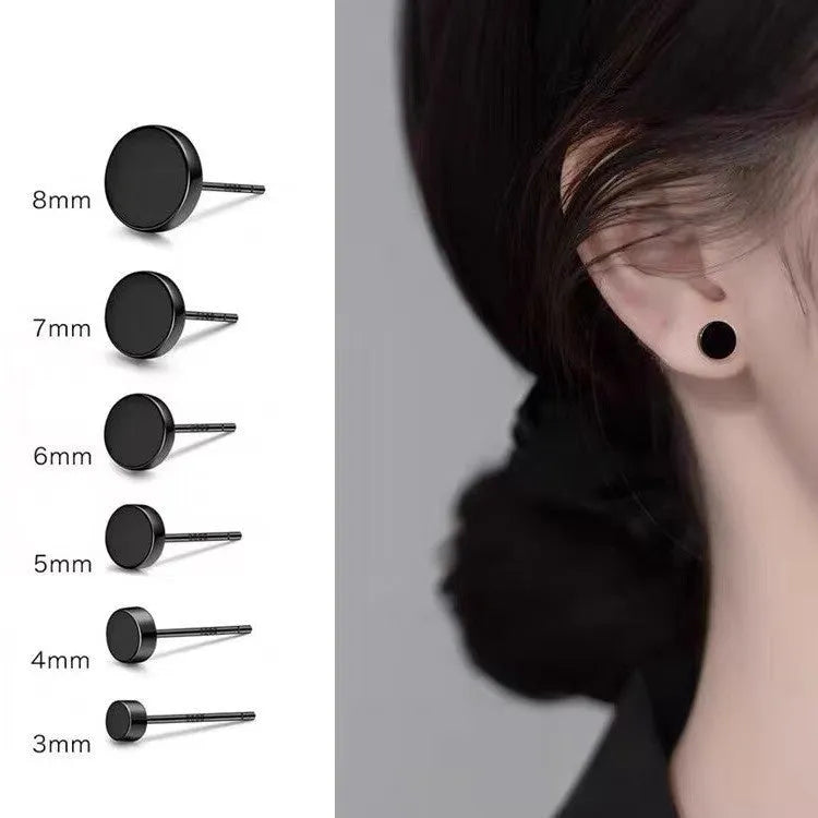 A pair of simple round S999 sterling silver flat ear bone studs on a plain background.