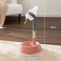 Green height-adjustable pet water dispenser with detachable pole and weighted bowl on a floor.