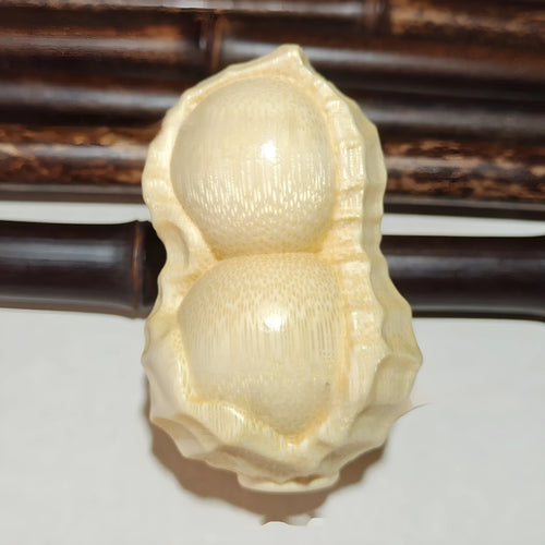 Carved bamboo peanut ornament with natural texture symbolising may good things happen
