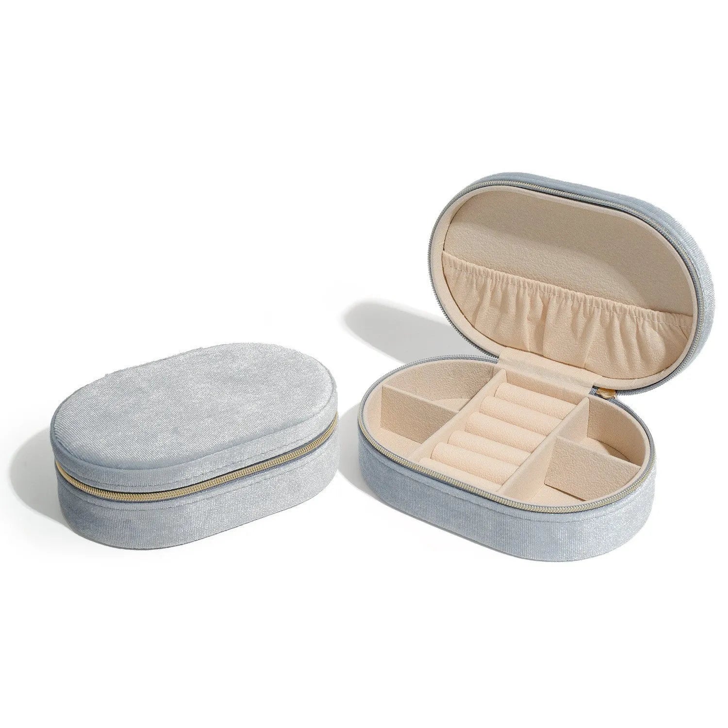 Oval velvet jewellery storage box in lake blue colour showing flannel interior and compact 15x10x5cm dimensions