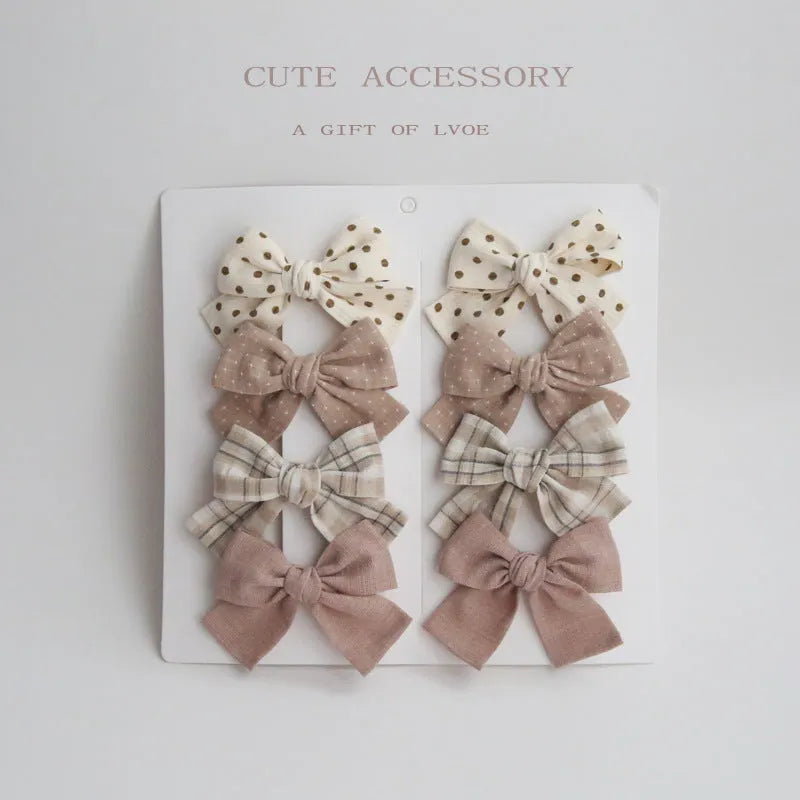 Children's fabric bow hairclips set showing dovetail design in multiple colour options