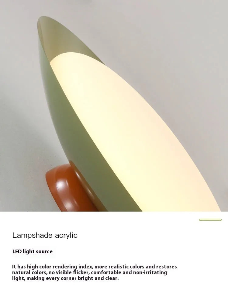 Modern minimalist flying saucer design ceiling lamp in cream yellow on a white ceiling.