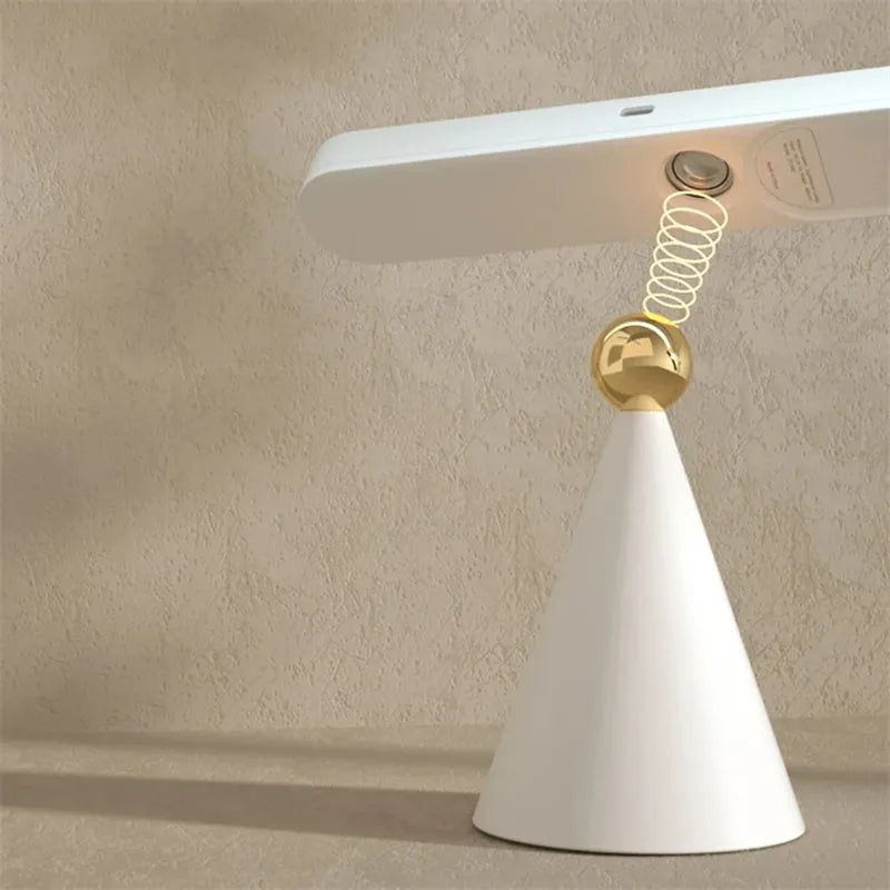 Geometric desk lamp with magnetic base shown attached to metal surface as wall light
