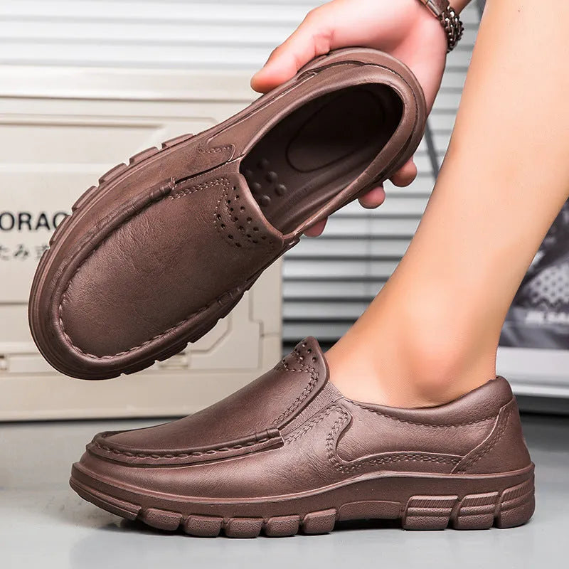 Men's black slip-on platform shoes with round toe and mid-top design on a white background.
