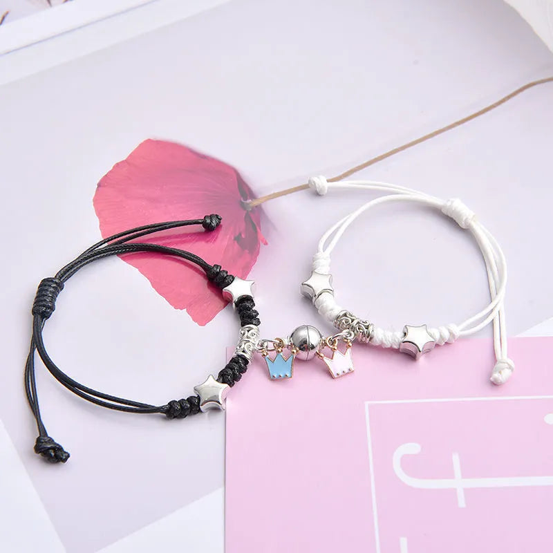 Pair of alloy suction bracelets with engraved symbol choices including crown, love lock, and clover.