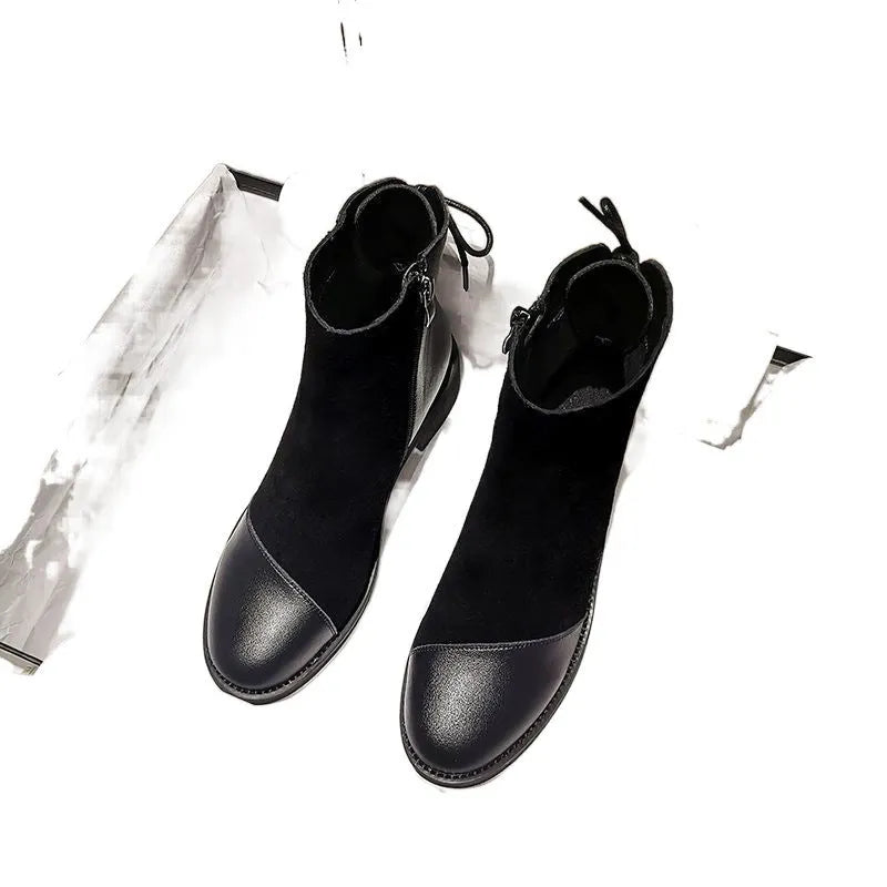 Black women's knee-high Martin boots with side zip and round toe on a short stout heel.