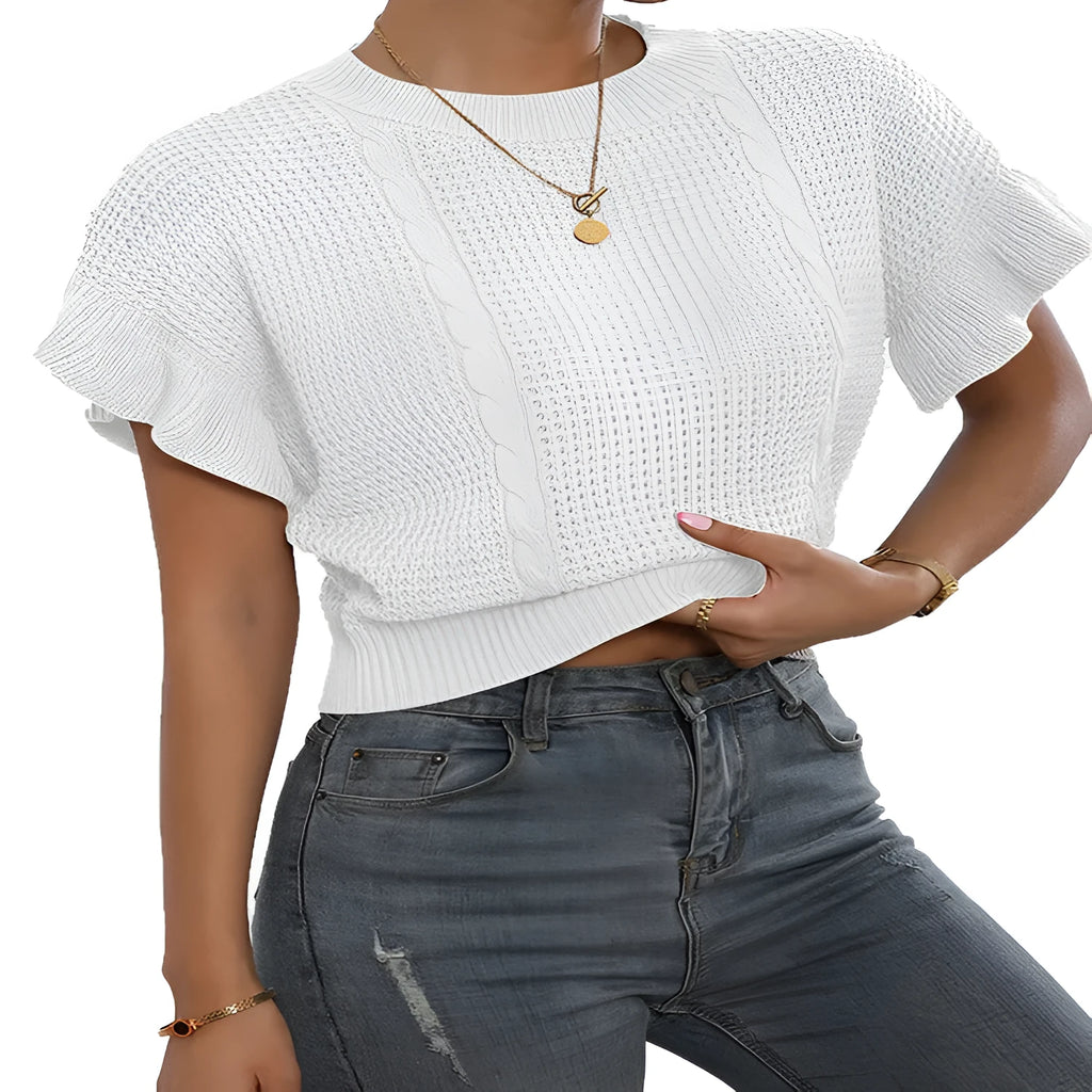 Loose-fitting white knitted pullover sweater with textured ruffled short sleeves on a model.