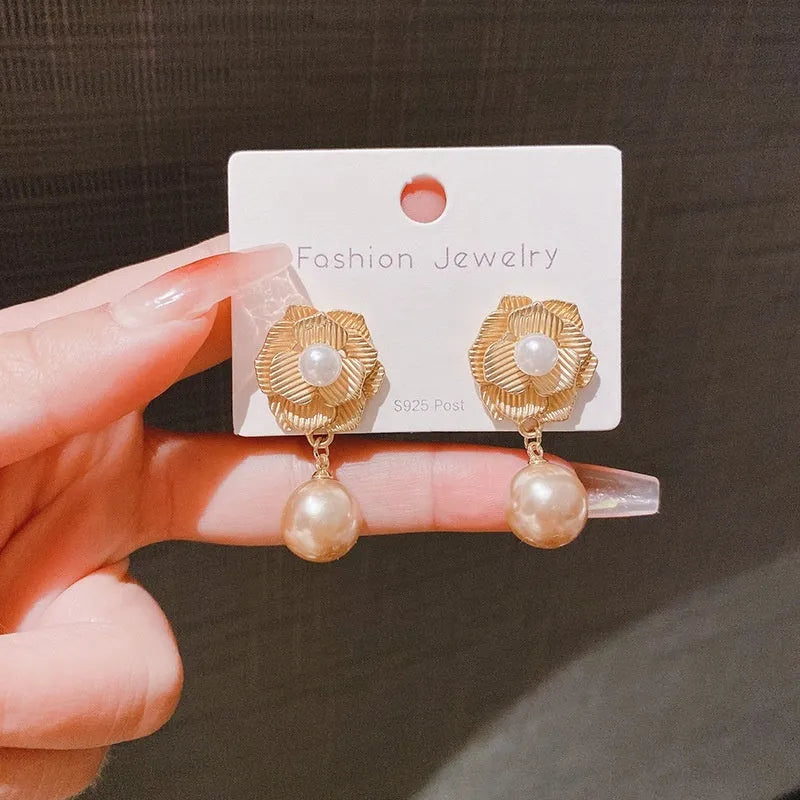 Gold-toned stud earrings with Hong Kong style ice flower design and centre opal stone