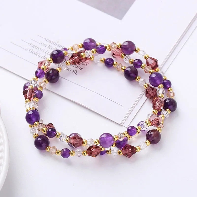 Three-ring crystal bracelet with tourmaline, strawberry quartz and amethyst stones on adjustable tightening rope