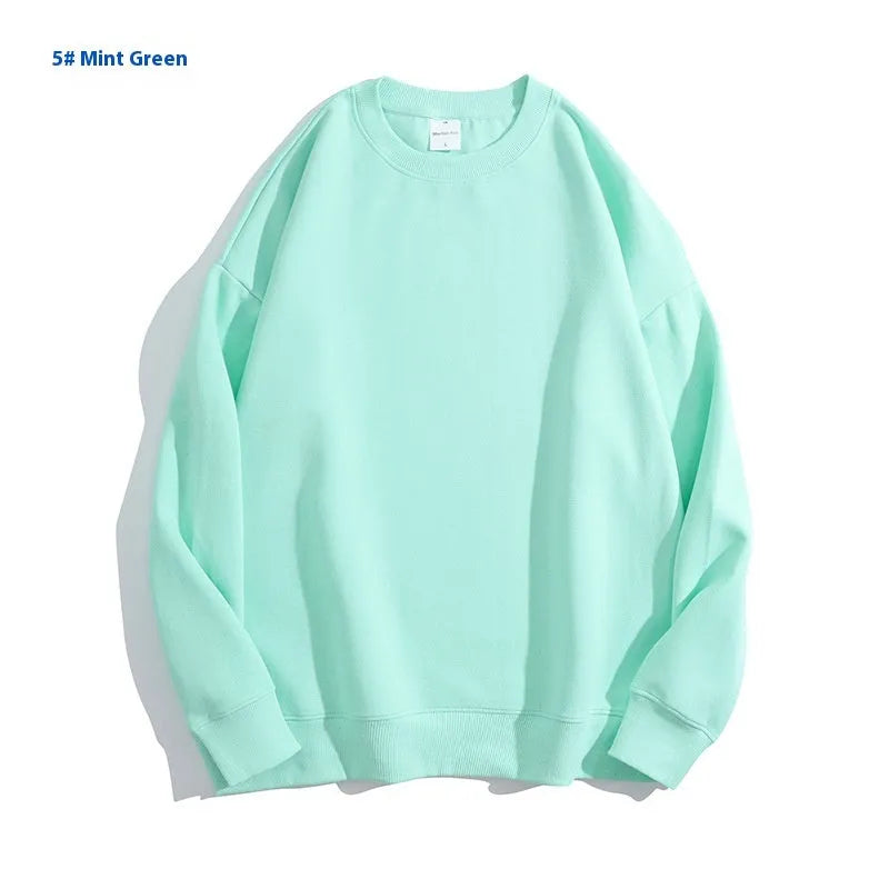 A loose round neck off shoulder pullover sweater in a solid colour, with long sleeves.