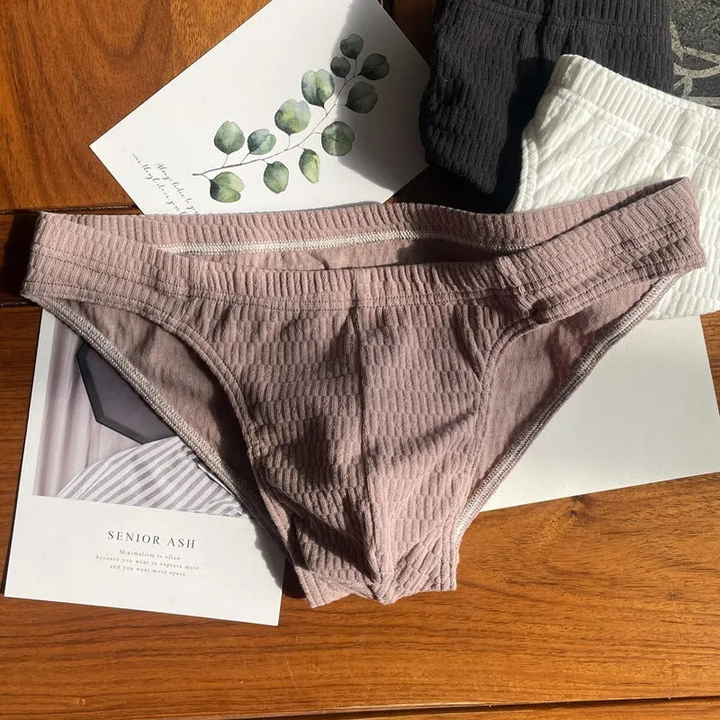 Men's solid colour cotton briefs with a mid waist and triangle design.