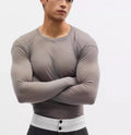 Black mesh see-through slim-fit long sleeve women's pullover top on a hanger.