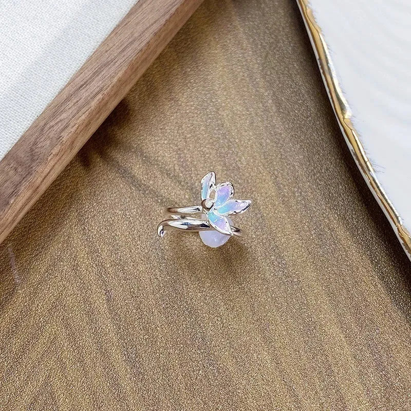 Copper insect fashion ring with adjustable band and drip oil finish on a hand.