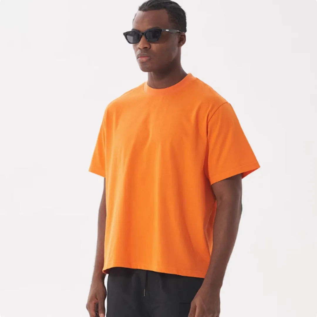 Men's loose fit pure cotton T-shirt in apricot colour on a hanger